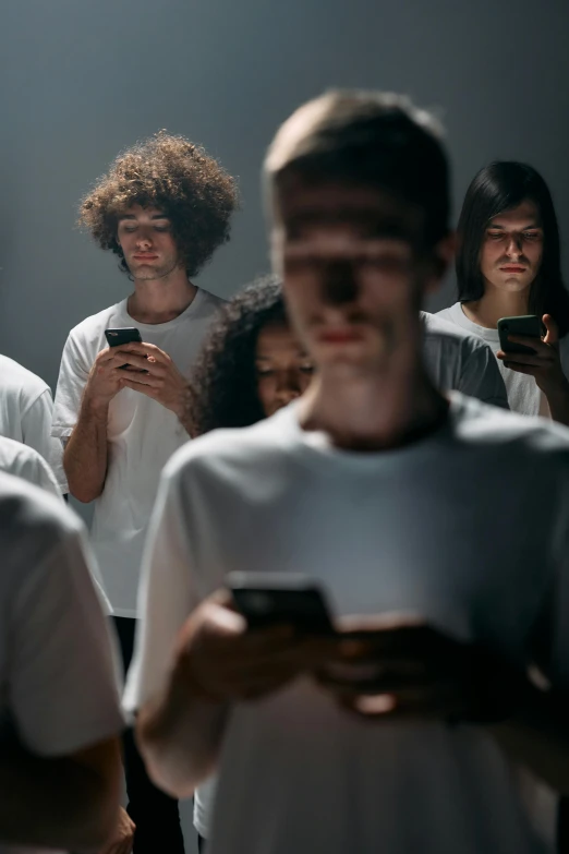 a group of people looking at their cell phones, a hologram, trending on pexels, antipodeans, looking serious, ignant, 6 : 3 0 am, large)}]