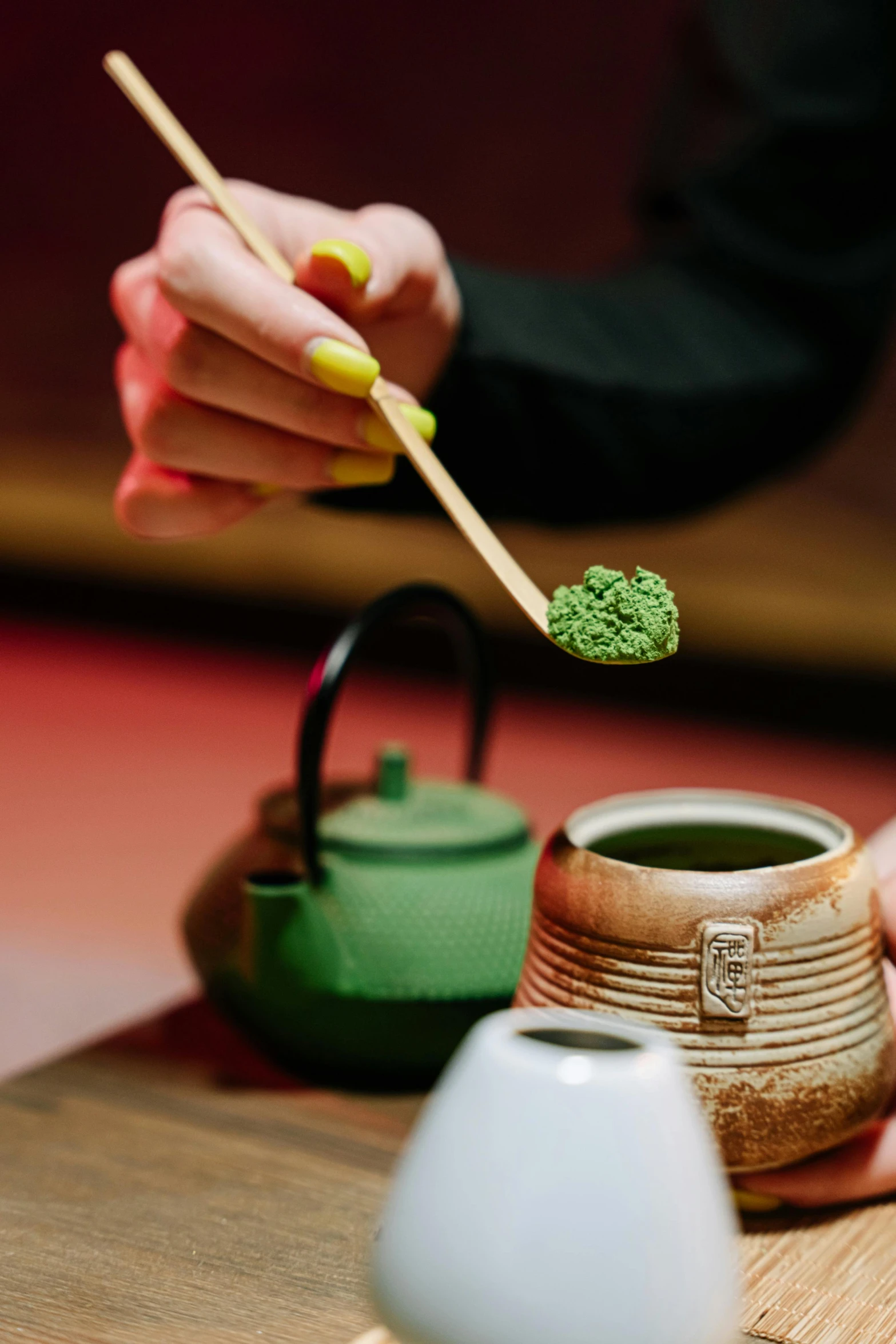 a person holding chopsticks over a bowl of food, teapots, light green and deep blue mood, loputyn and matcha, ground broken