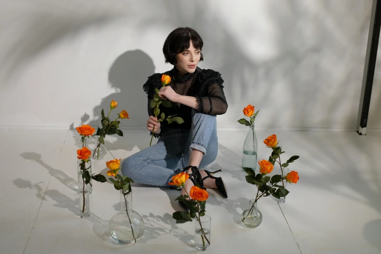 a woman sitting on the floor surrounded by vases of flowers, an album cover, pexels, sophia lillis, charli xcx, melanchonic rose soft light, portrait image