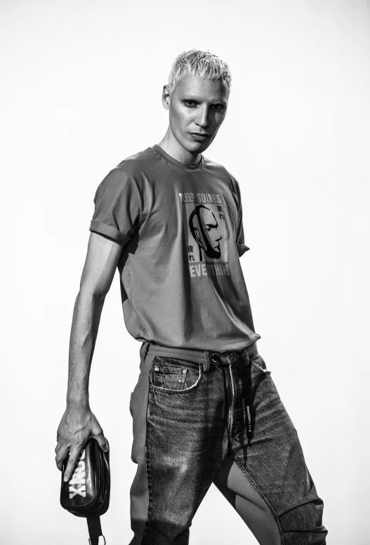 a black and white photo of a man holding a baseball glove, inspired by Richard Avedon, dribble, jeans and t shirt, die antwoord yolandi portrait, model photograph, young male