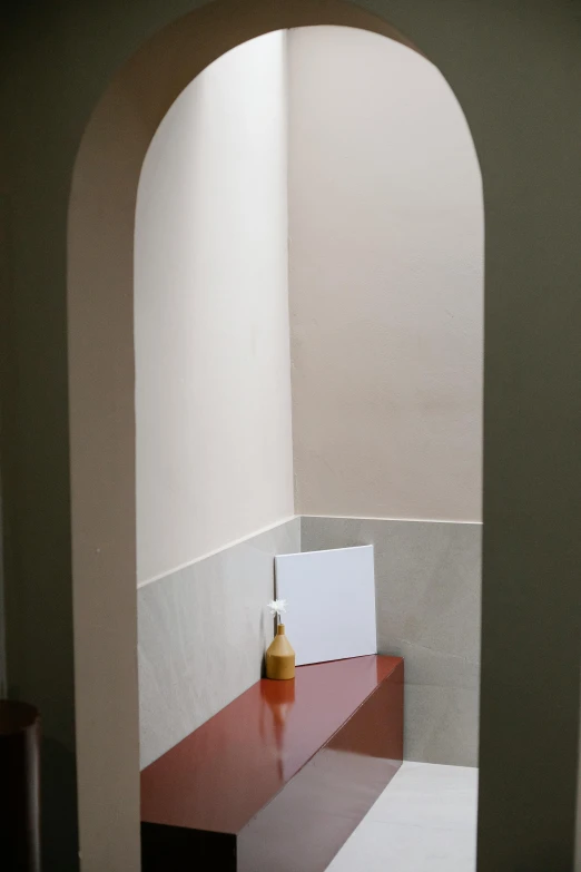 a bath room with a toilet a sink and a mirror, by Riad Beyrouti, postminimalism, archway, art station ”, dslr photo of a vase on a table, ( ( photograph ) )