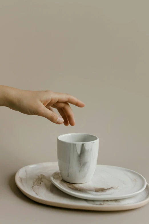 a person reaching for a cup on a plate, a marble sculpture, inspired by Caro Niederer, trending on unsplash, soft mist, detailed product image, portrait of small, small