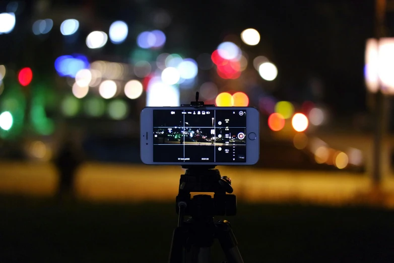 a cell phone sitting on top of a tripod, pexels, vfx powers at night in the city, bokeh. i, rectangle, iphone