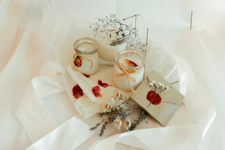 a close up of a plate of food on a table, jars, petals, cream and white color scheme, listing image