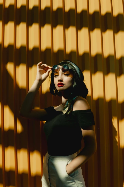 a woman standing in front of a yellow wall, inspired by Elsa Bleda, trending on pexels, surrealism, jet black haired cyberpunk girl, with sunglass, young asian woman, melanie martinez