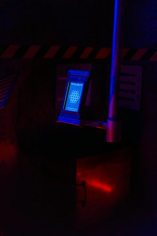 a laptop computer sitting on top of a desk in a dark room, holography, post - apocalyptic epcot center, in the dark elevator, blue and red lights, entering the mind maze