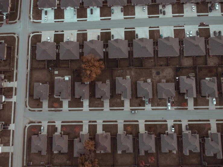 an aerial view of a neighborhood with lots of houses, pexels contest winner, grainy photorealistic, perfect symmetrical image, brown, spooky photo