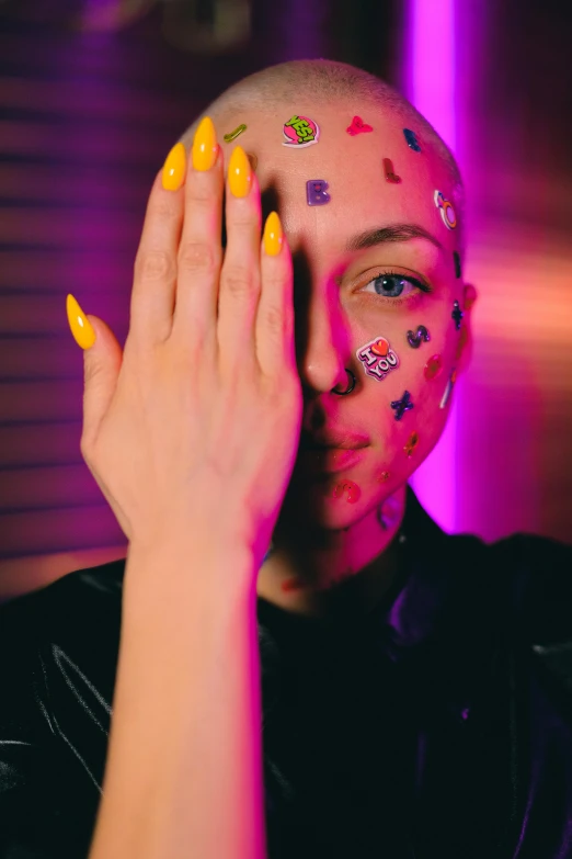 a woman with tattoos covering her face with her hands, an album cover, by Julia Pishtar, trending on pexels, antipodeans, yellow neon cyborg eyes, bald patch, pete davidson, with index finger