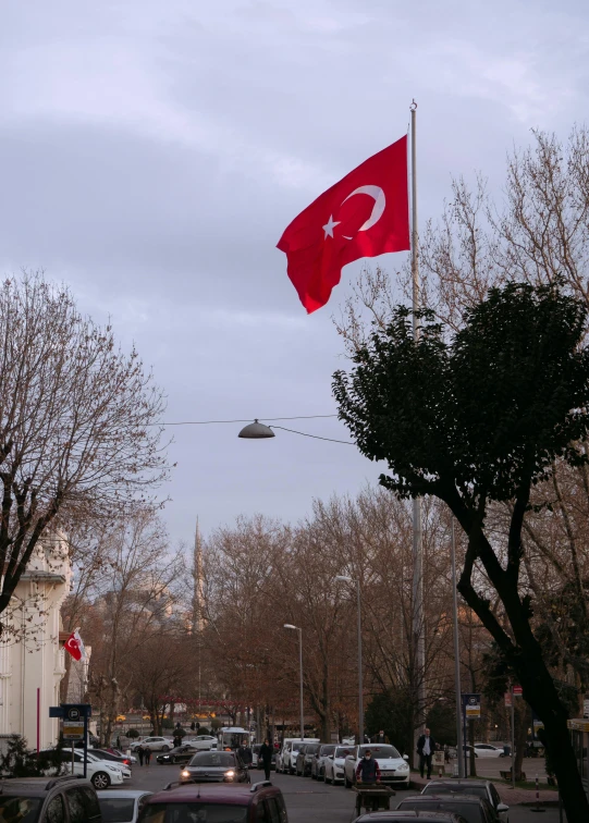 a turkish flag flying over a city street, slide show, january, photo”