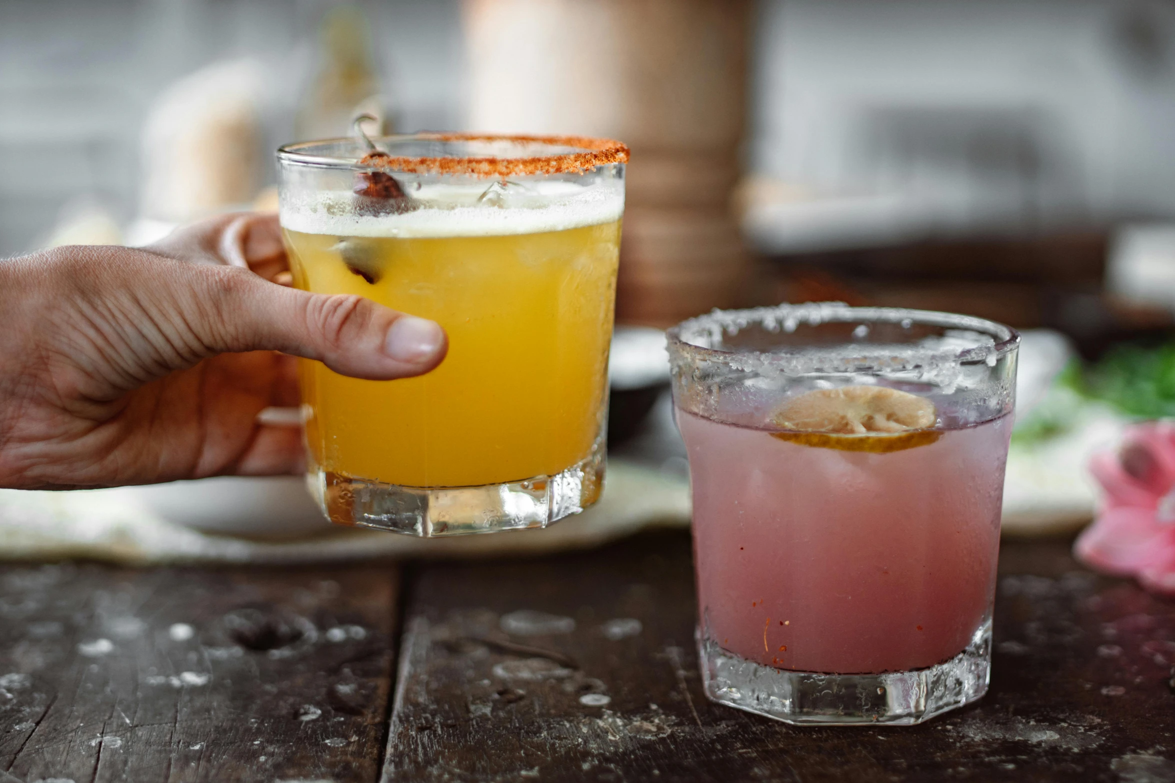 a close up of two glasses of drinks on a table, mexican standoff, hand on table, straya, square