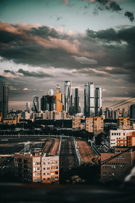 a view of a city from the top of a building, pexels contest winner, socialist realism, dragon invasion of moscow, dramatic skies, tall metal towers, gif