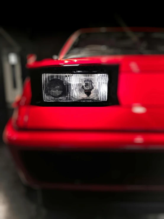 a red car is parked in a garage, a portrait, unsplash, hyperrealism, custom headlights, kitt, on display in a museum, promo image