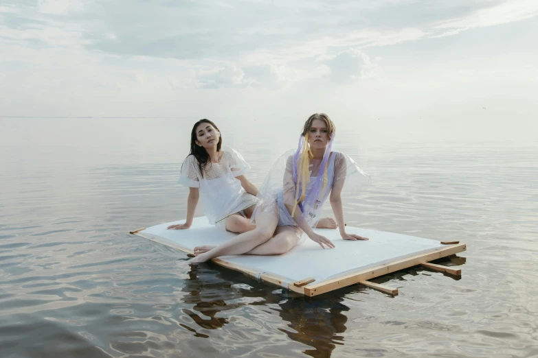 two women sitting on a floating platform in the water, a portrait, unsplash, conceptual art, midsommar style, marat zakirov, portrait image, ruan jia and fenghua zhong