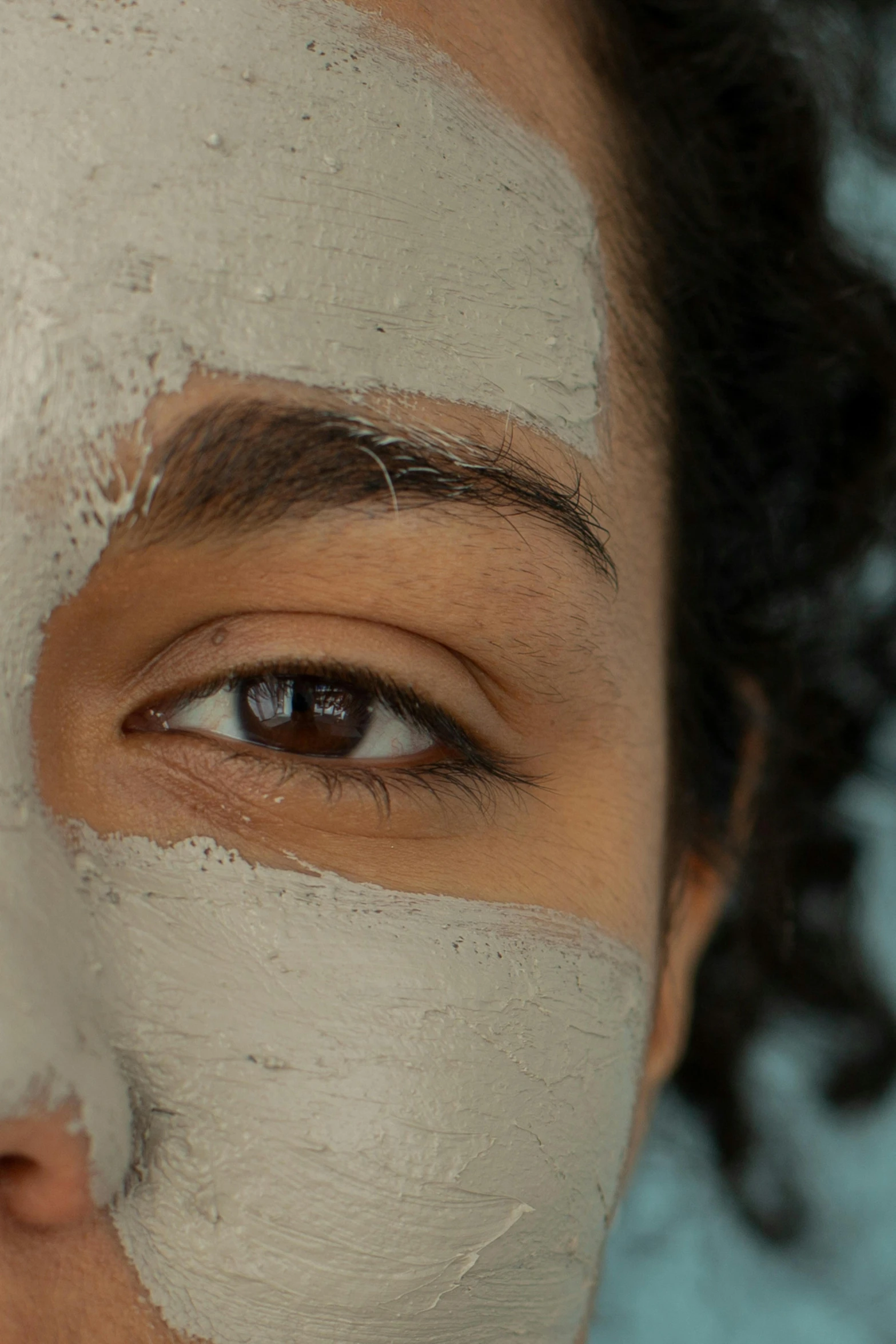 a close up of a person with a face mask, by Arabella Rankin, trending on pexels, square facial structure, eye - level medium shot, beauty campaign, grey