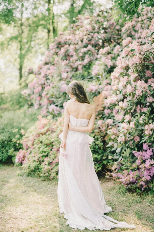 a woman in a white dress standing in front of flowers, unsplash, romanticism, dressed in a pink dress, wedding photo, portra 8 0 0 ”, 15081959 21121991 01012000 4k