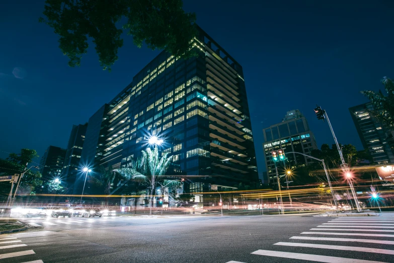 a city street filled with lots of traffic at night, pexels contest winner, office building, outdoors tropical cityscape, thumbnail, stacked image