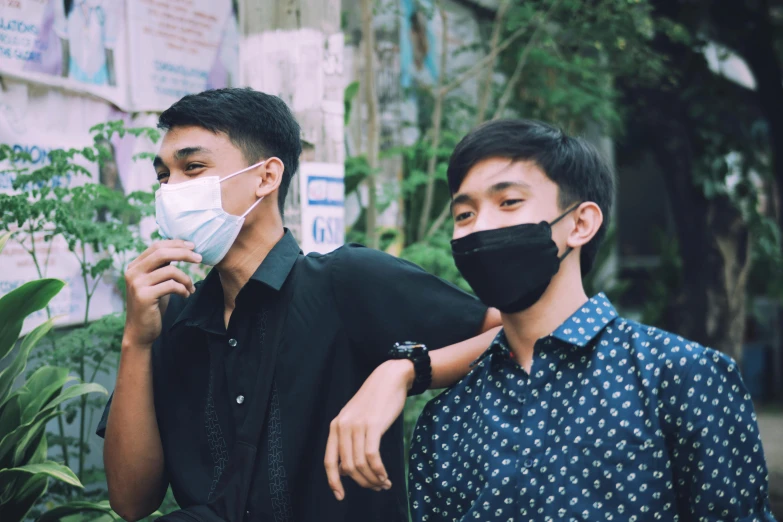 a couple of men standing next to each other, pexels contest winner, surgical mask covering mouth, teenagers, south east asian with round face, avatar image