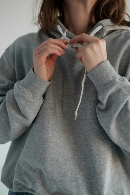 a close up of a person wearing a hoodie, grey hoodie, product view, ready to model, set photo