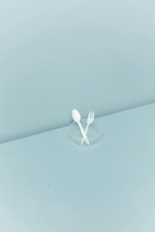 a fork and spoon sitting on top of a table, inspired by Cerith Wyn Evans, minimalism, miniature cafe diorama, translucent material, promo image, icon