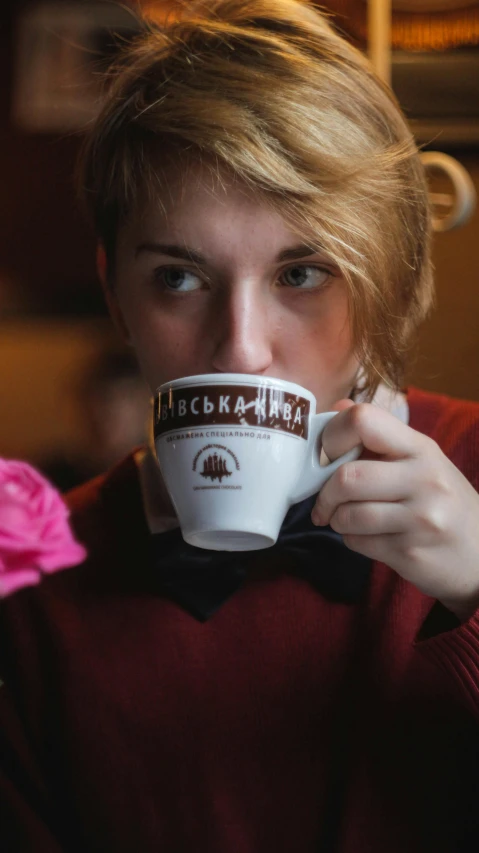 a woman holding a coffee cup in front of her face, pexels, art nouveau, anna kovalevskaya, high quality photo, thumbnail, hot cocoa drink
