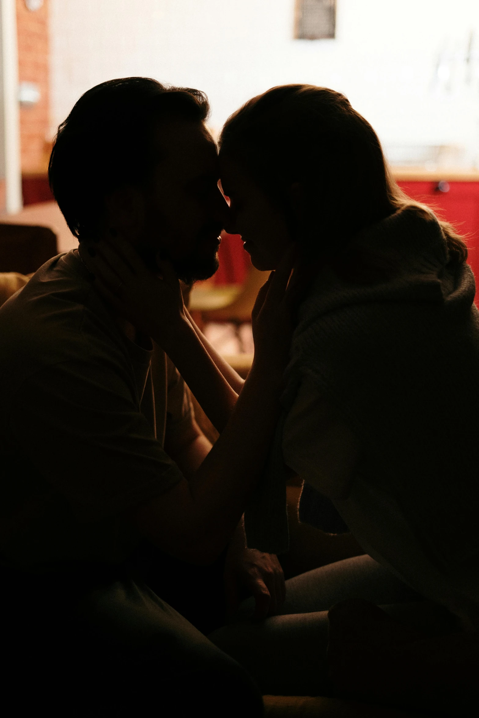 a man and a woman sitting on a couch kissing, inspired by Nan Goldin, pexels, back lit, ( ( theatrical ) ), portrait shot 8 k, instagram post