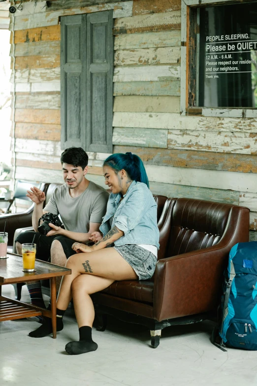 a group of people sitting on top of a brown couch, small hipster coffee shop, twins playing video games, ska skeleton and girlfriend, aussie baristas