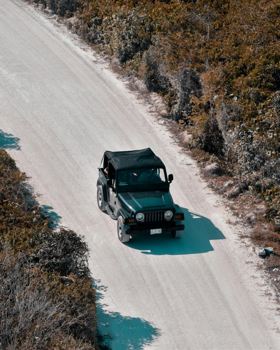 a green jeep driving down a dirt road, pexels contest winner, photorealism, white sand, top down shot, soft top, thumbnail