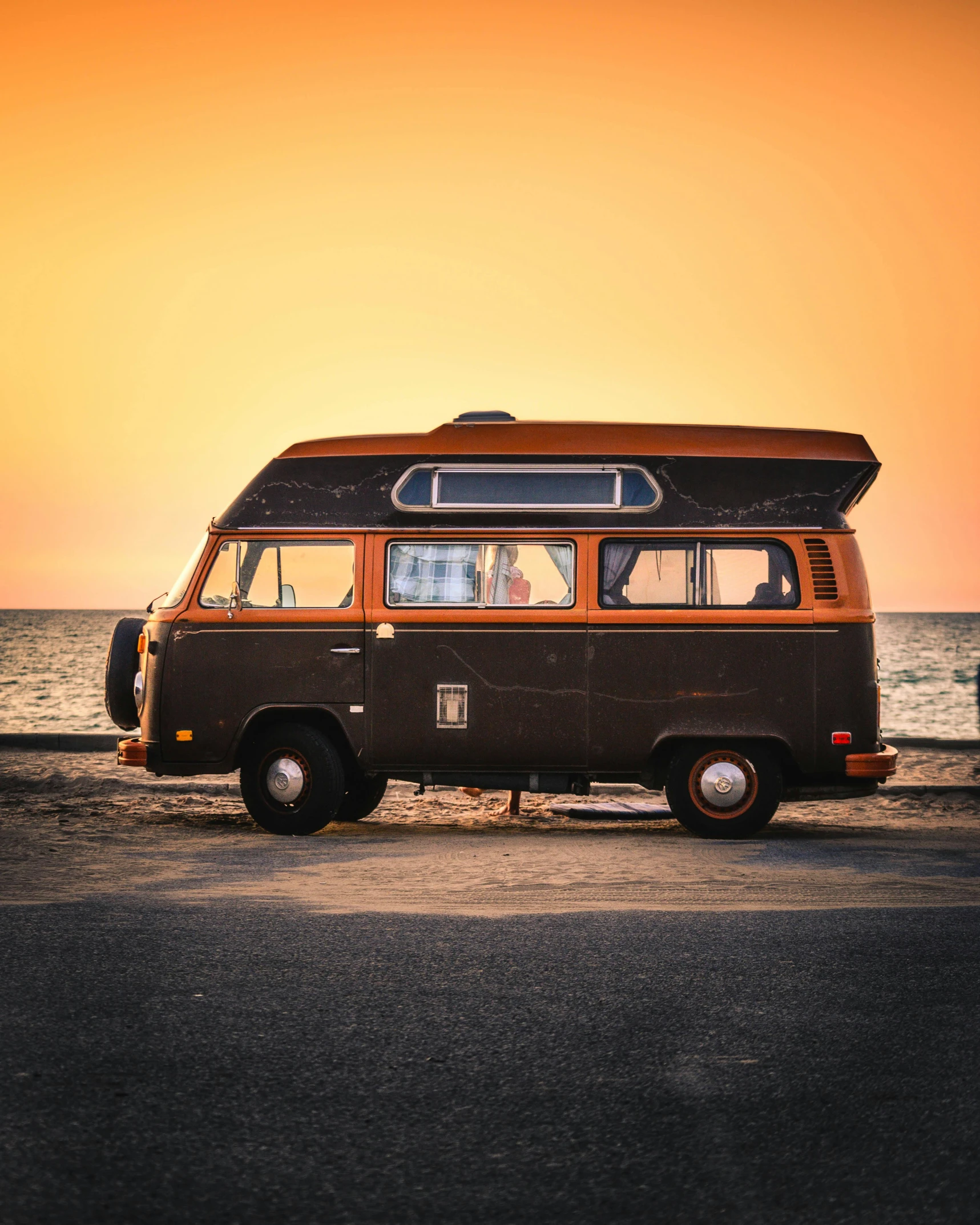 a van parked on the side of a road next to the ocean, profile image