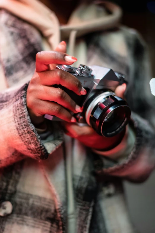 a close up of a person holding a camera, a picture, coloured film photography, red camera, low colour, unblur