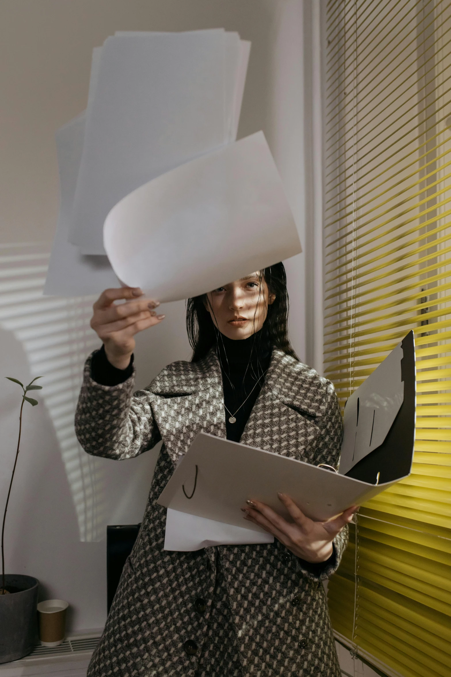 a woman holding a piece of paper over her head, by Julia Pishtar, pexels contest winner, conceptual art, working in an office, tall female emo art student, multi-part, holding a clipboard