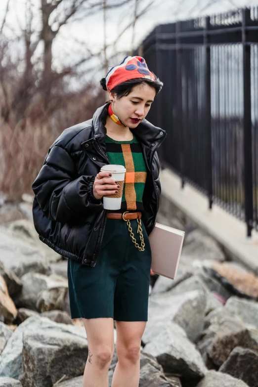 a woman standing on top of a pile of rocks, a portrait, inspired by Winona Nelson, trending on pexels, model wears a puffer jacket, gucci clothes, wearing a beret, hong june hyung