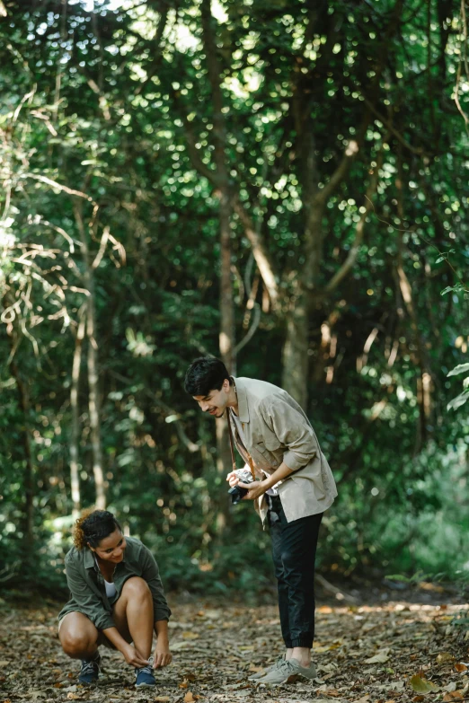 a couple of people that are in the woods, unsplash, visual art, malaysia jungle, movie set”, having a snack, on ground