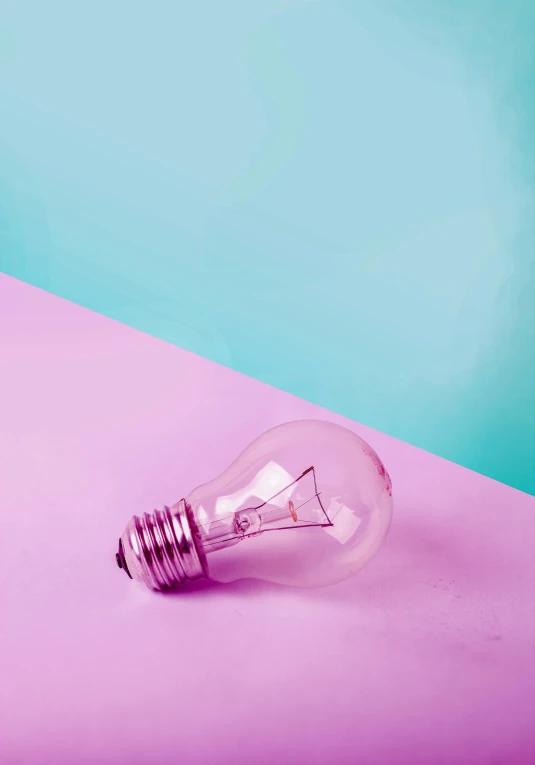 a light bulb sitting on top of a pink and blue surface, pexels contest winner, bright style, light purple, leftlight, instagram picture