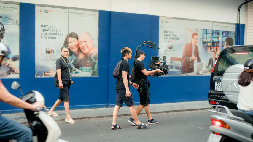 a group of people walking down a street, unsplash, video art, panavision millennium xl 2, movie set, smiling for the camera, filmposter