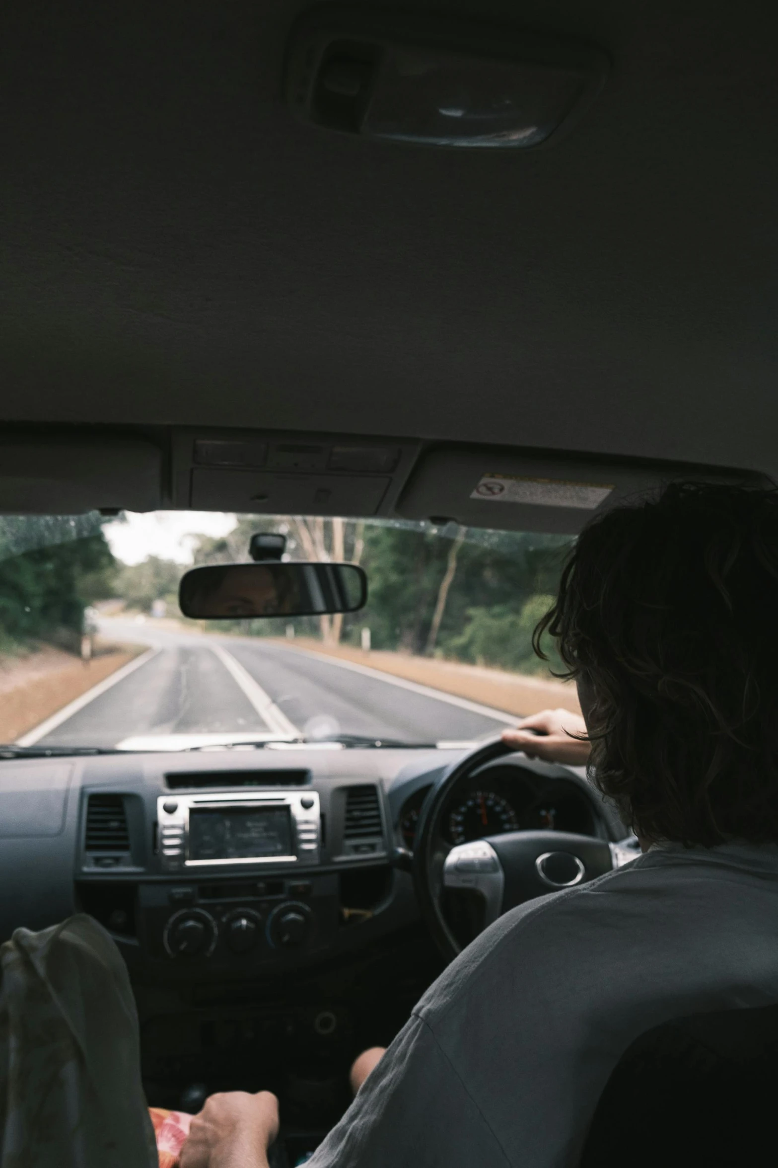 a couple of people that are sitting in a car, a picture, trending on unsplash, pov from rear, australian, 8k octan photo, driving