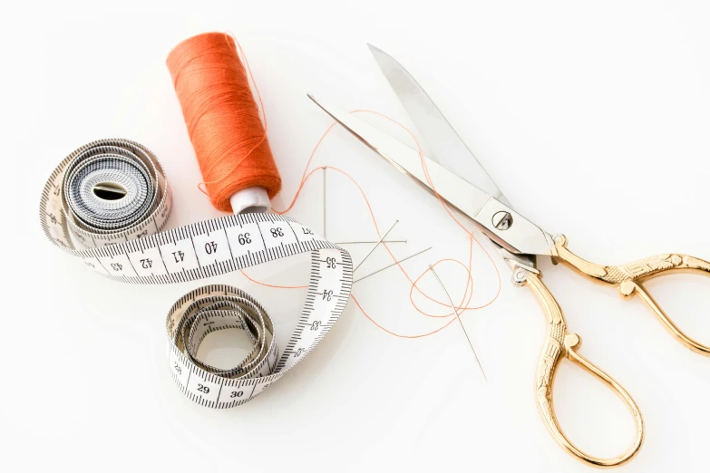 a pair of scissors sitting next to a spool of thread, thumbnail, designer clothes, embellishment, measurements