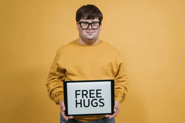 a man holding a sign that says free hugs, an album cover, pexels, thick glasses, avatar for website, cute young man, surreautistic