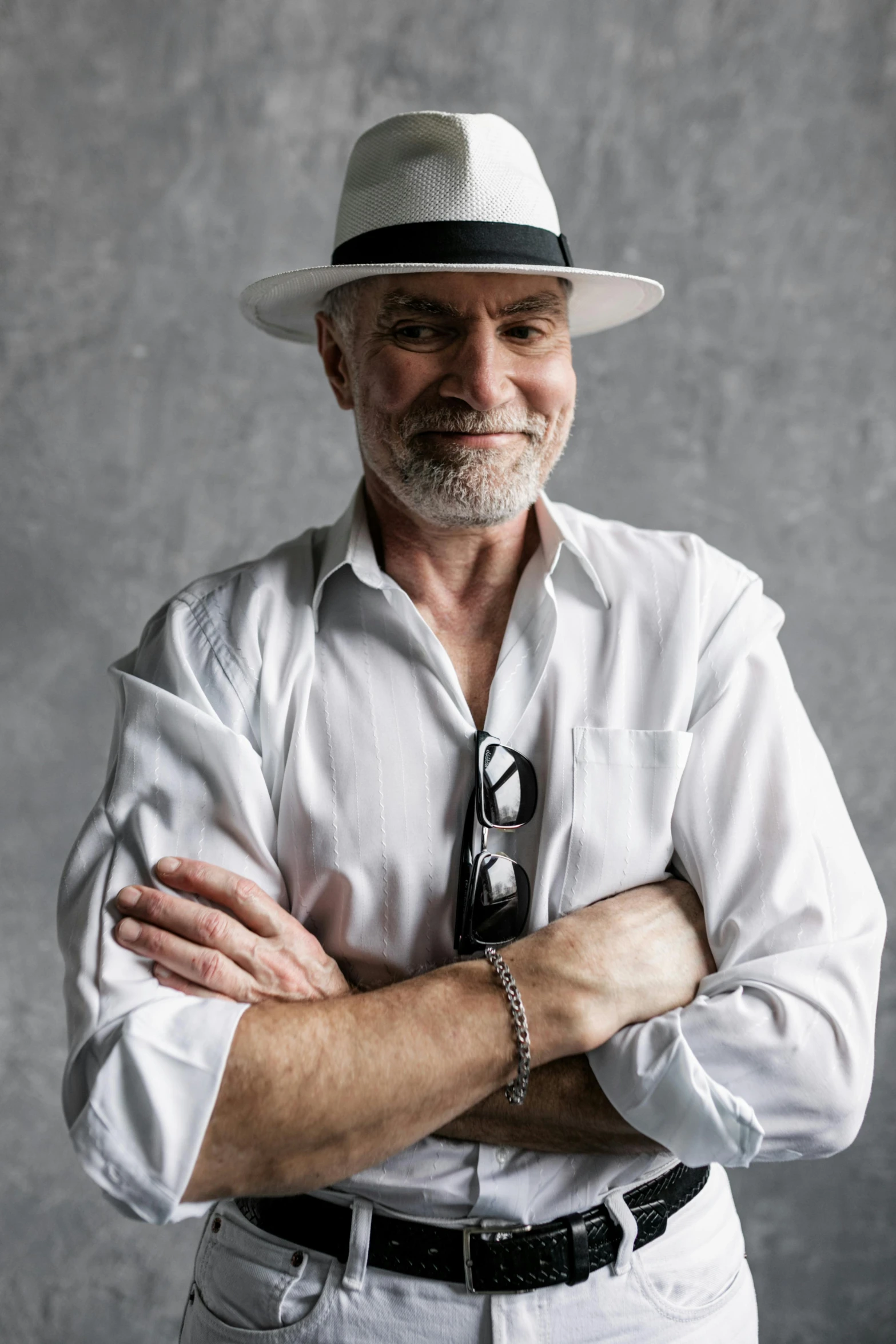 a man in a white shirt and hat posing for a picture, inspired by Peter Maxwell Ewart, 5 5 yo, white on black, very stylish, metabaron