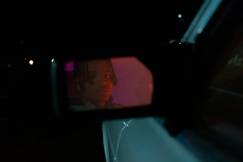 a woman's reflection in the rear view mirror of a car, an album cover, inspired by Nan Goldin, unsplash, realism, trippie redd, nighttime scene, still from riverdale, movie still of a cyborg