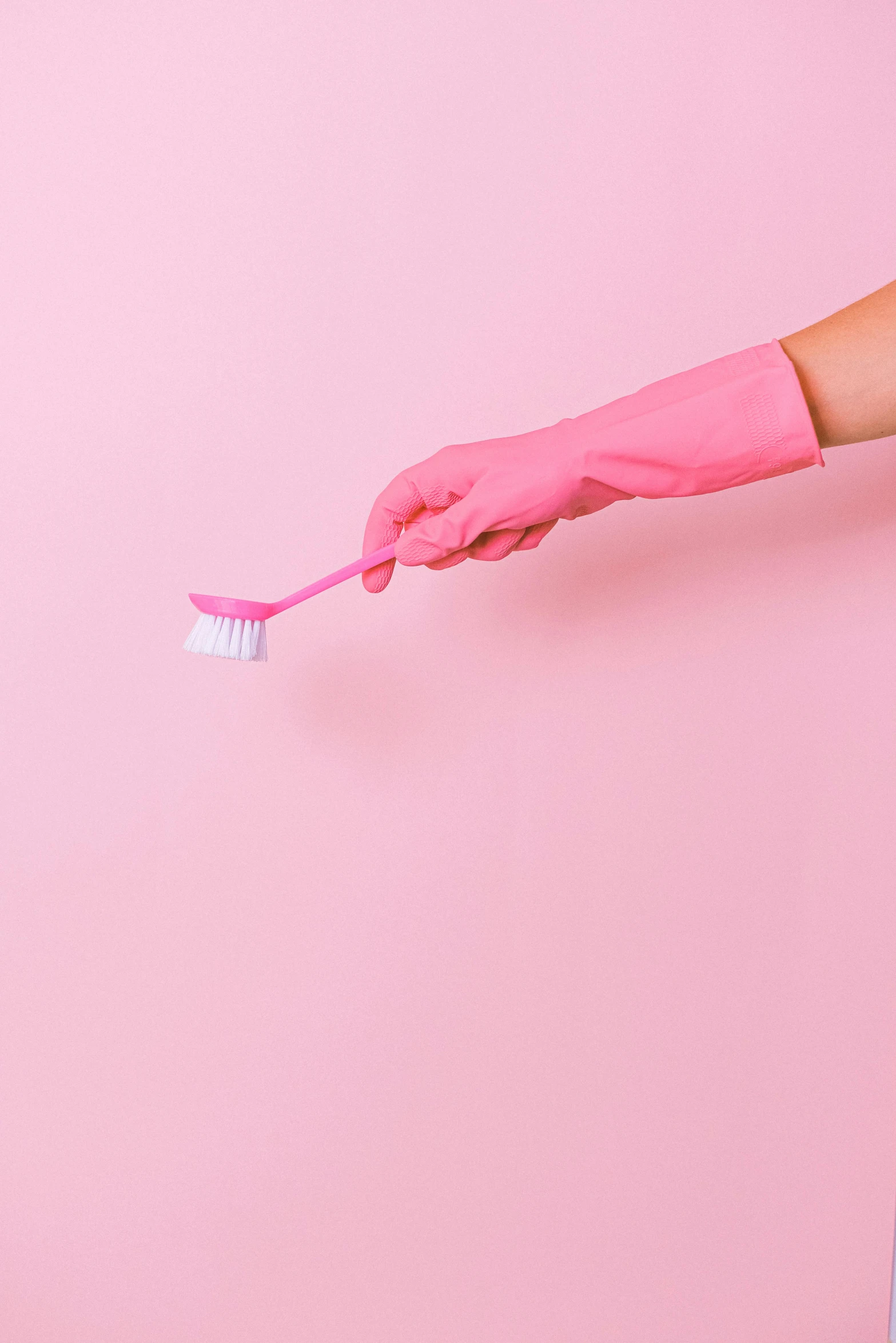 a person in pink gloves holding a toothbrush, clean and pristine design, ((pink)), sweeping, jen atkin