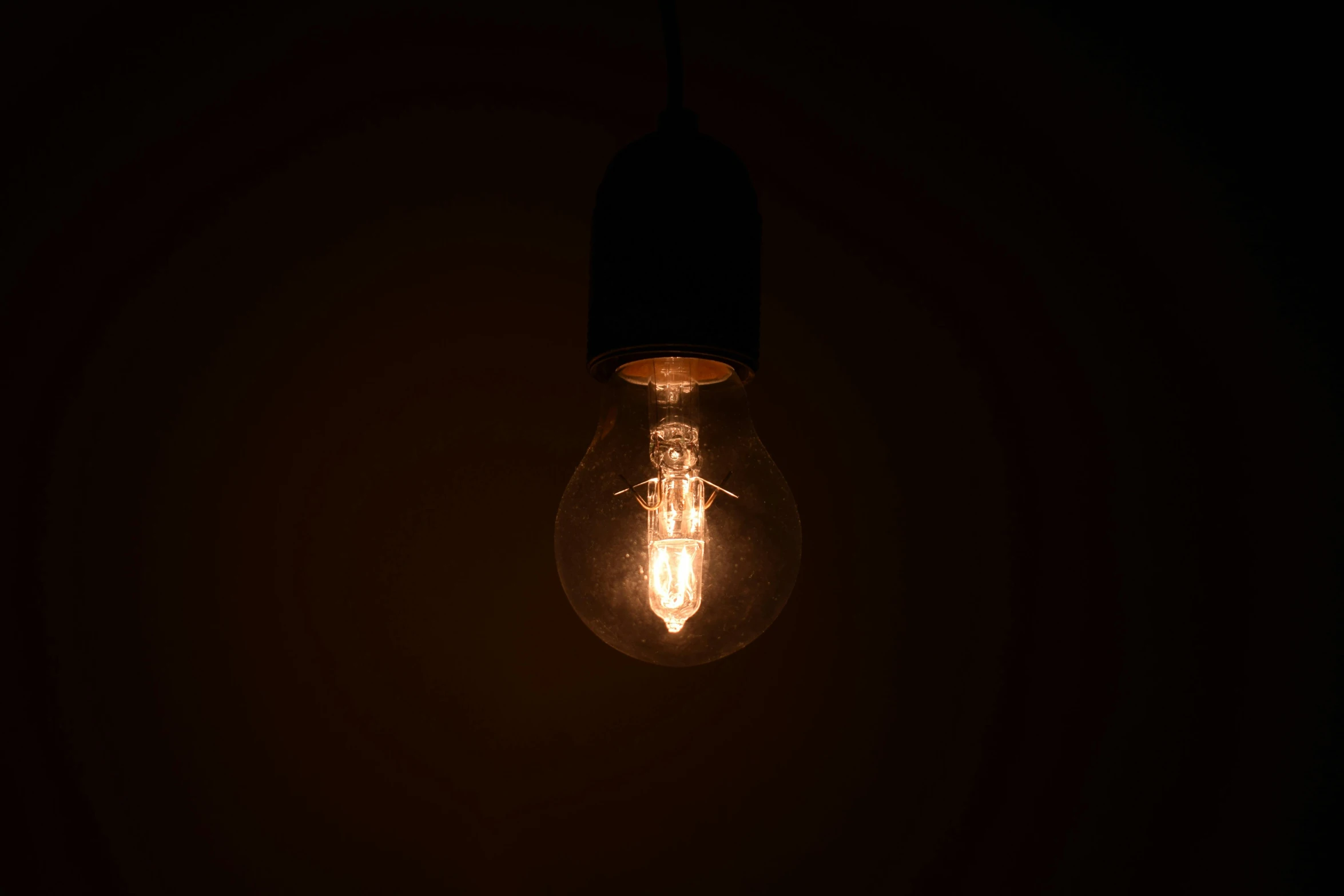 a light bulb lit up in the dark, inspired by Elsa Bleda, pexels, brown, experimental studio light, bottom lighting, laura watson