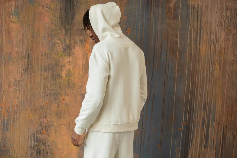 a man in a white hoodie holding a tennis racquet, inspired by Kanō Hōgai, renaissance, back turned, light cream and white colors, tracksuit, handcrafted