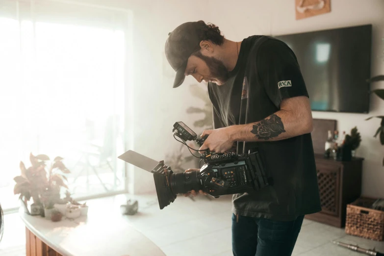 a man standing in a living room holding a camera, production ig, **cinematic, worksafe. cinematic, high quality action photography