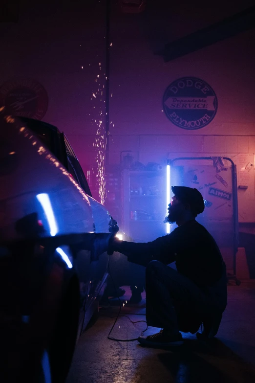 a man working on a motorcycle in a garage, by Ryan Pancoast, pexels contest winner, kinetic art, light sabers, party lights, foam, faded glow