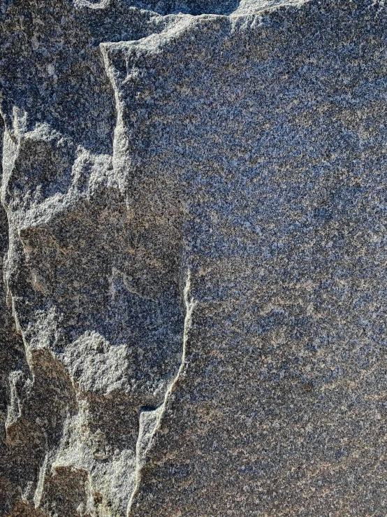 a man riding a snowboard down a snow covered slope, an album cover, unsplash, conceptual art, stylized stone cladding texture, ((rocks)), microscopic detail, granite