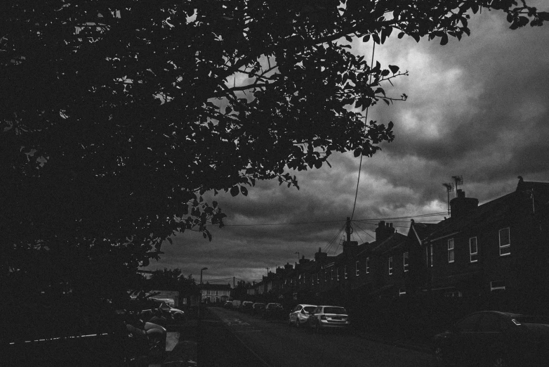 a black and white photo of a street, by Adam Rex, blackened clouds cover sky, alex heywood, gloomy weather. high quality, low fi