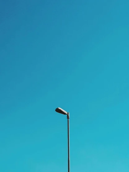 a street light sitting on the side of a road, by James Morris, postminimalism, azure blue sky, instagram picture, today\'s featured photograph 4k, miscellaneous objects