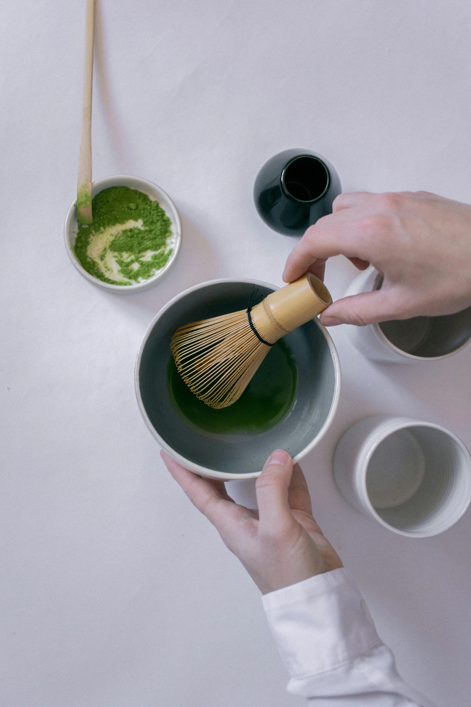 a person that is holding a whisk in a bowl, a picture, inspired by Kanō Shōsenin, trending on unsplash, green tea, avatar image, brushes, detailed product image