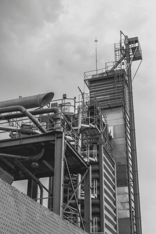 a black and white photo of a factory, 4k greyscale hd photography, portrait of tall, various refining methods, grain”