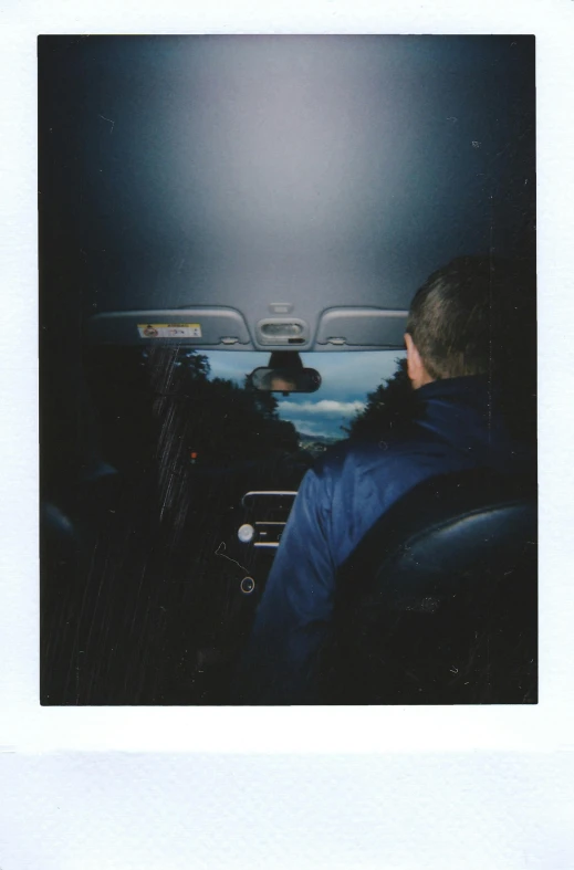 a man sitting in the passenger seat of a car, a polaroid photo, inspired by Nan Goldin, unsplash, scanned 2400 dpi, yung lean, rinko kawauchi, (night)